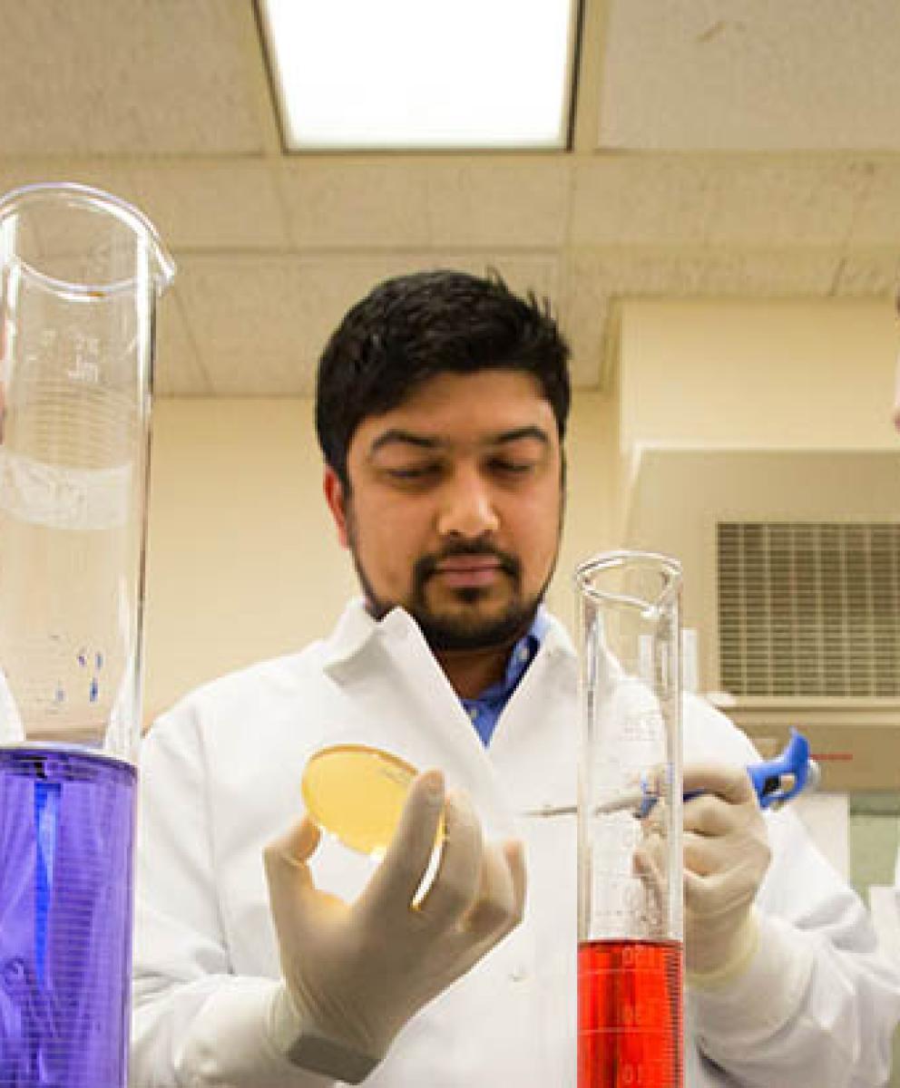 Dental research testing with three researchers in lab.